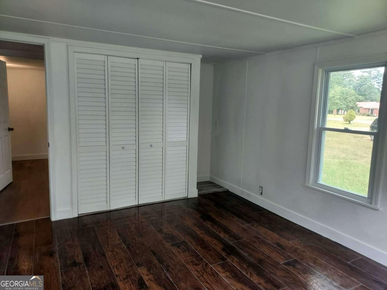 514 Phillips Road Warm Springs, GA 31830 - Photo 14 of 36 an empty room with wooden floor and windows