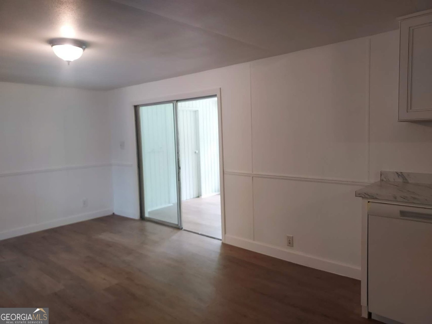 514 Phillips Road Warm Springs, GA 31830 - Photo 16 of 36 an empty room with wooden floor and windows
