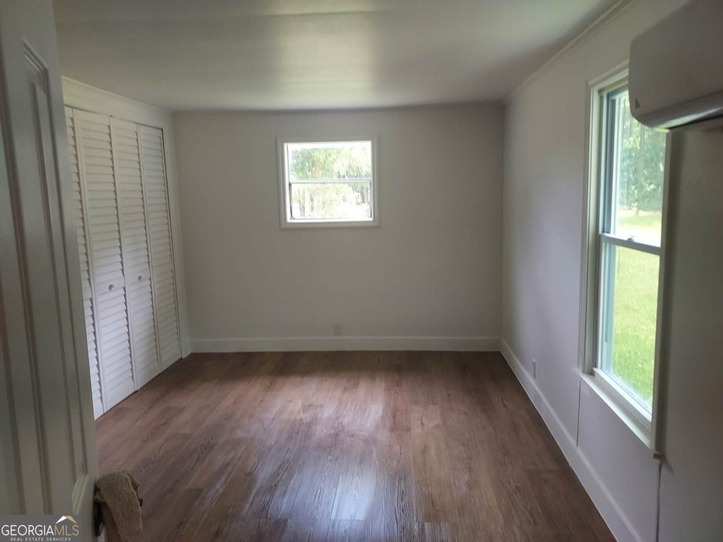 514 Phillips Road Warm Springs, GA 31830 - Photo 20 of 36 a view of an empty room with wooden floor and a window