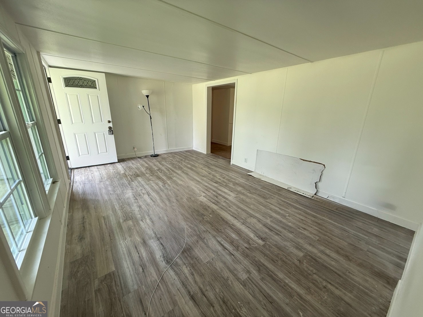 514 Phillips Road Warm Springs, GA 31830 - Photo 26 of 36 a view of an empty room with wooden floor and a window