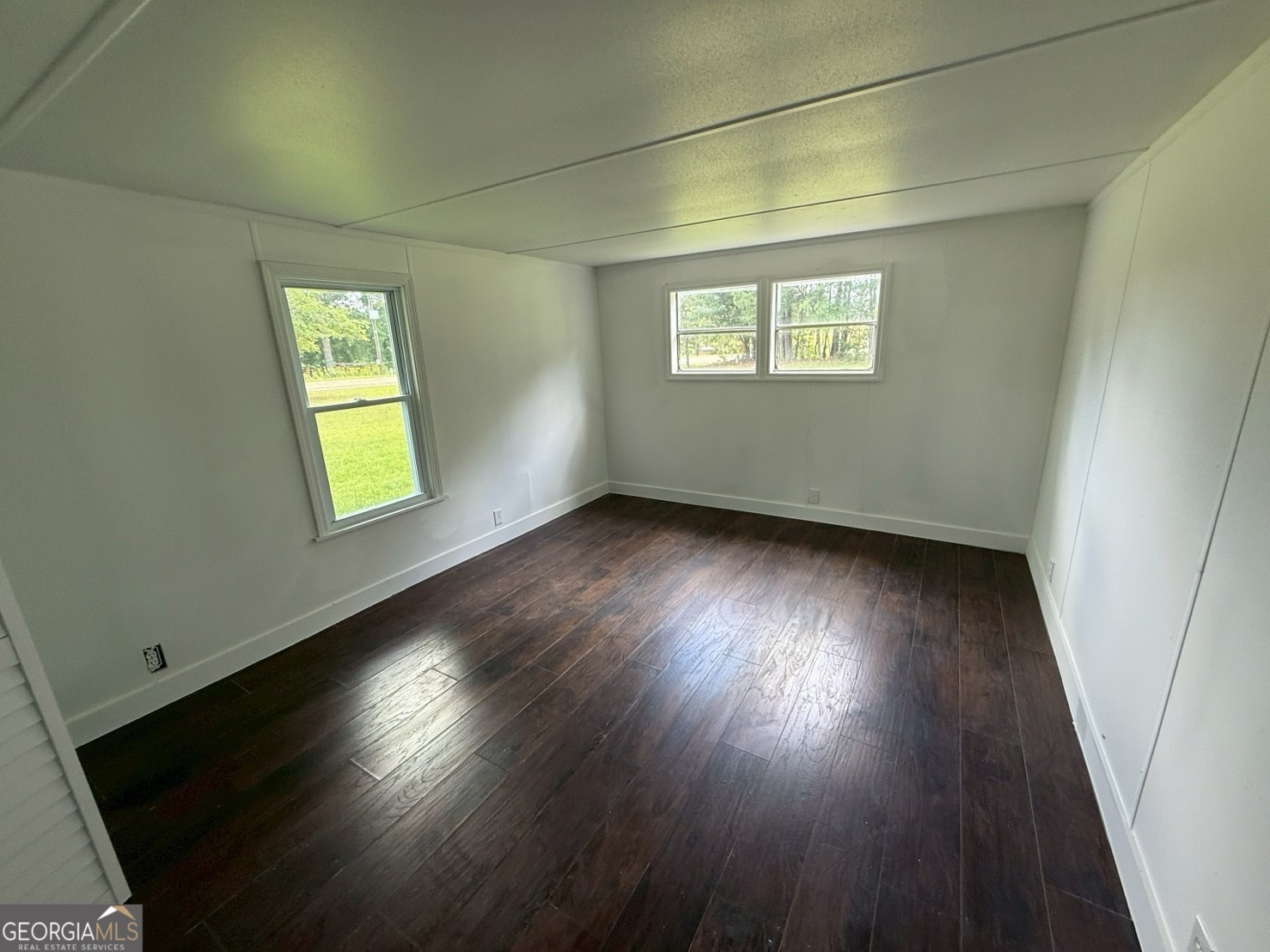 514 Phillips Road Warm Springs, GA 31830 - Photo 27 of 36 an empty room with wooden floor and windows