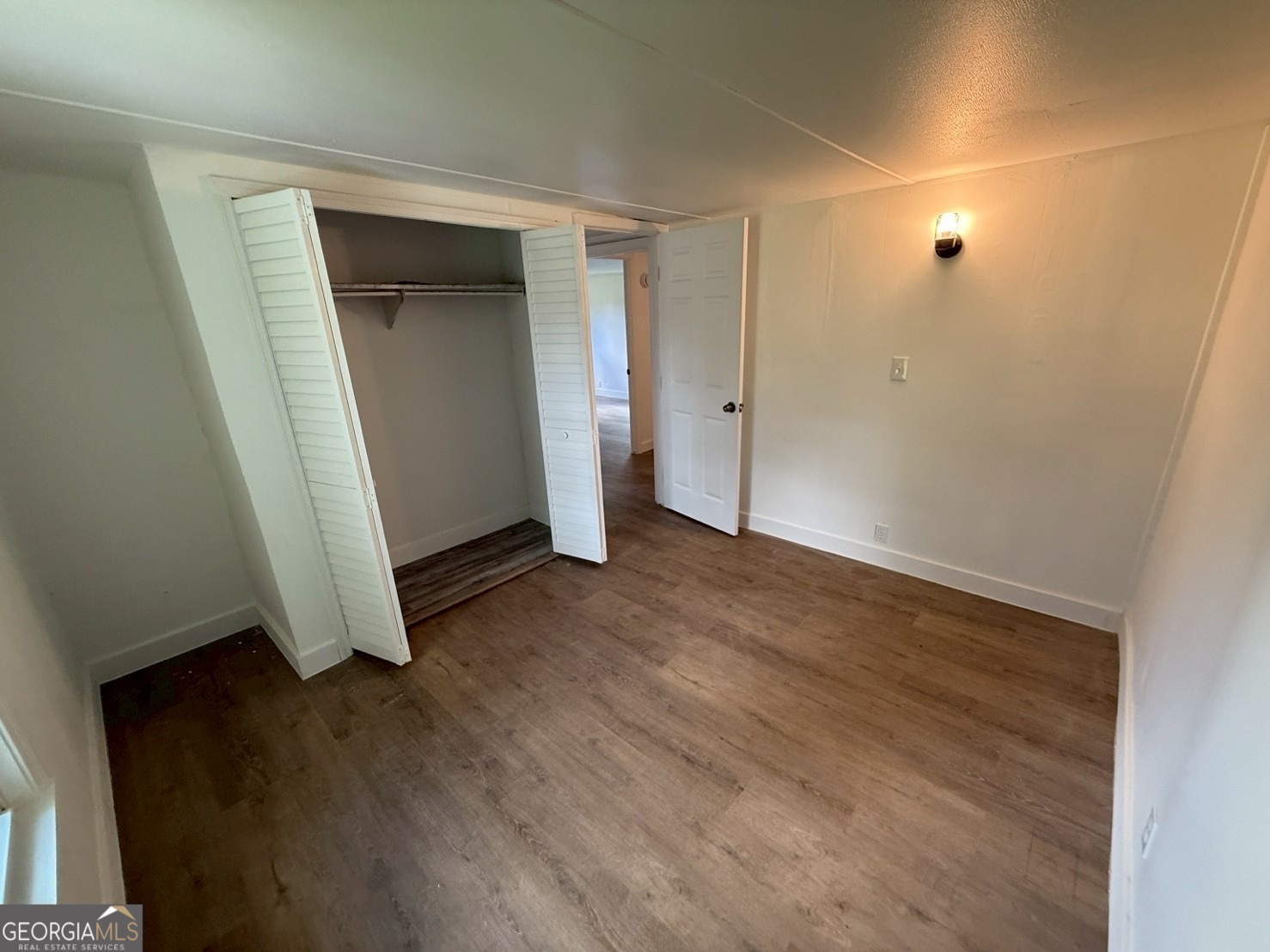 514 Phillips Road Warm Springs, GA 31830 - Photo 29 of 36 an empty room with wooden floor and closet