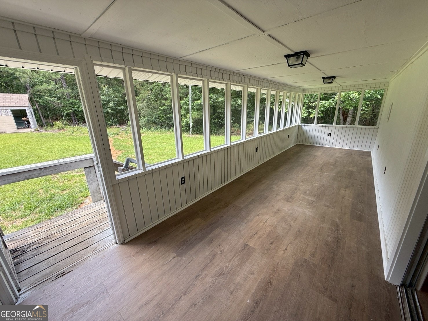 514 Phillips Road Warm Springs, GA 31830 - Photo 31 of 36 a view of an empty room with wooden floor and a large window