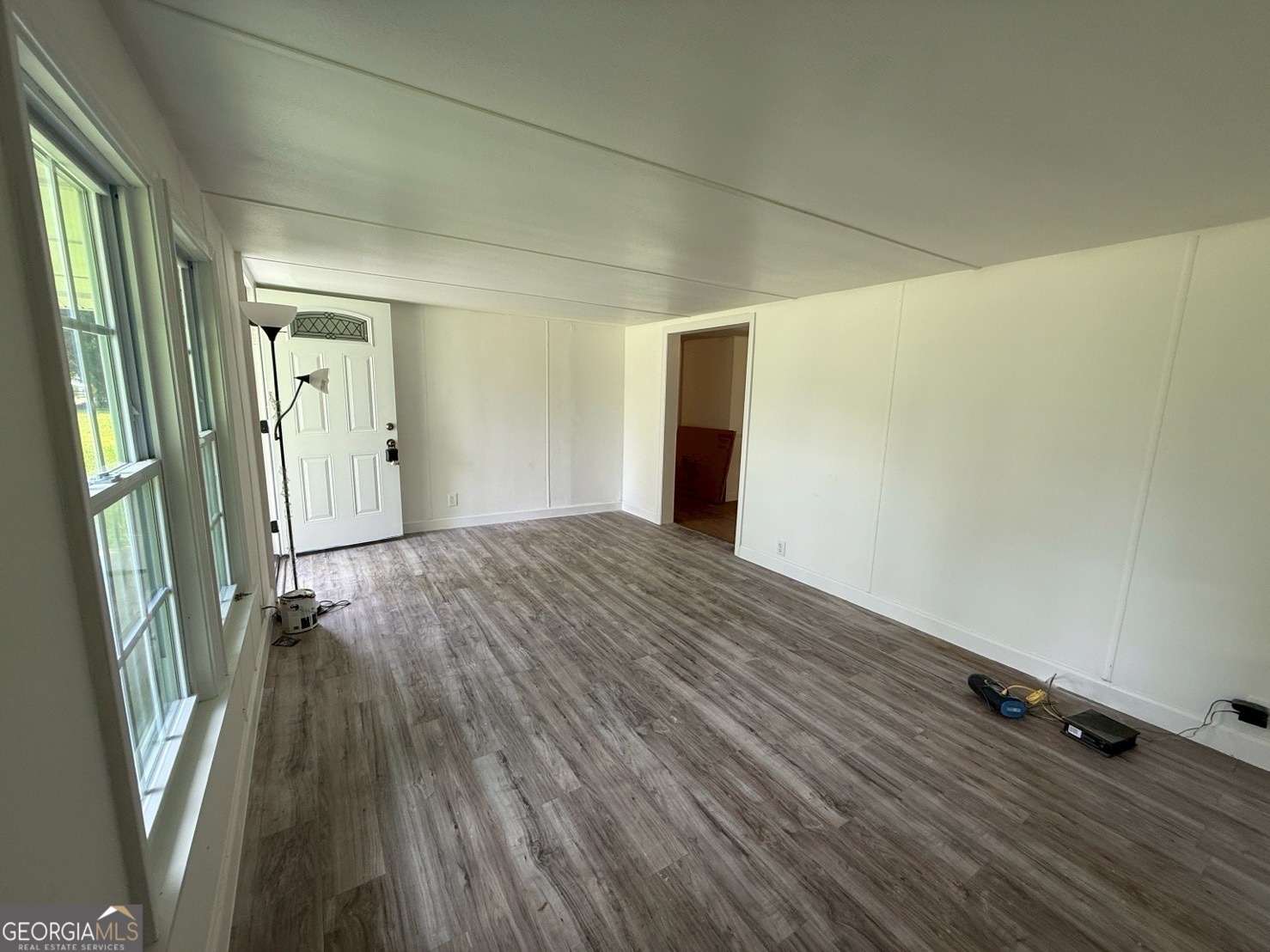 514 Phillips Road Warm Springs, GA 31830 - Photo 9 of 36 a view of an empty room with wooden floor and a window
