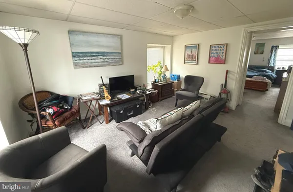 a living room with furniture window and a flat screen tv