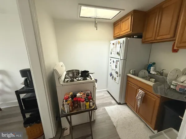 a kitchen with stainless steel appliances granite countertop a refrigerator stove and sink