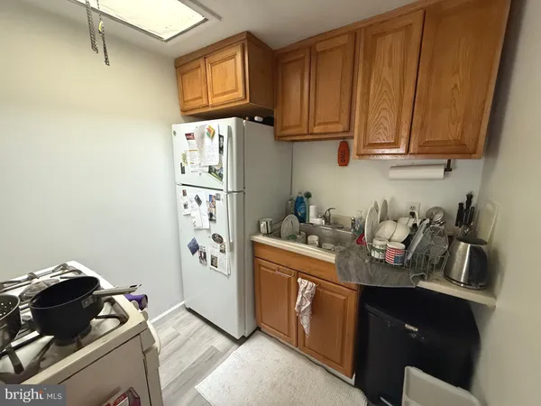 a kitchen with stainless steel appliances granite countertop a refrigerator stove and sink