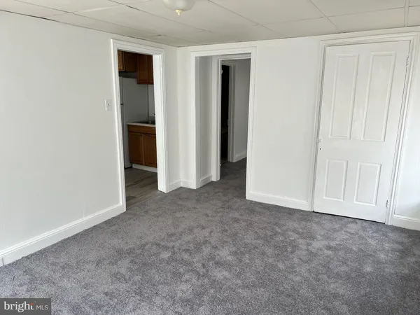 an empty room with closet and natural light