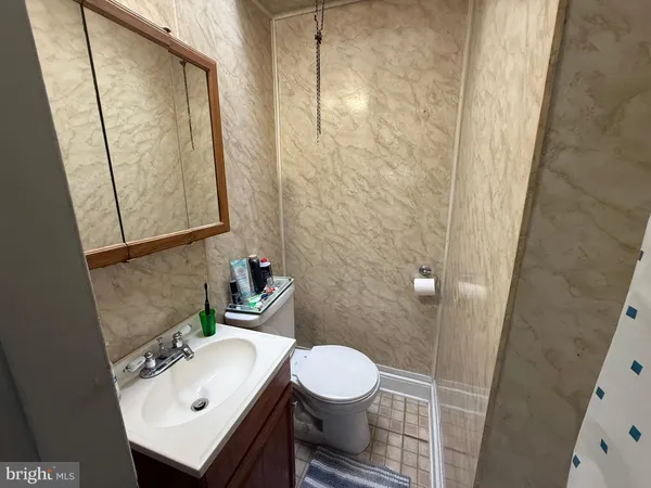 a bathroom with a sink a toilet and a mirror