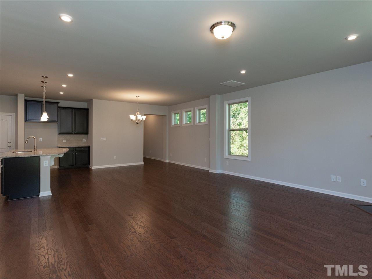 845 Rymark Court Cary, NC 27513 - Photo 12 of 21 an empty room with wooden floor and windows