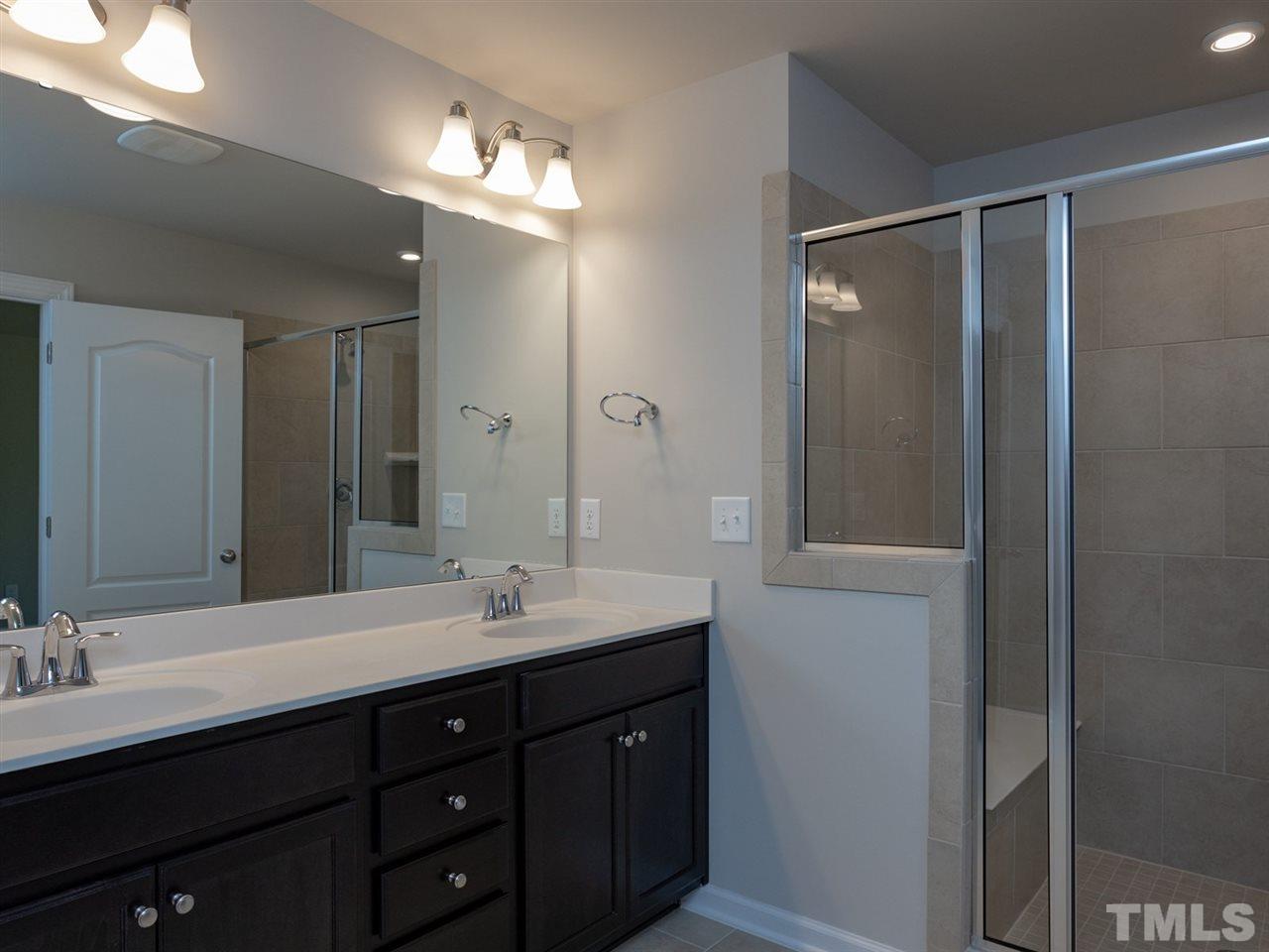 845 Rymark Court Cary, NC 27513 - Photo 16 of 21 a bathroom with a double vanity sink and a mirror