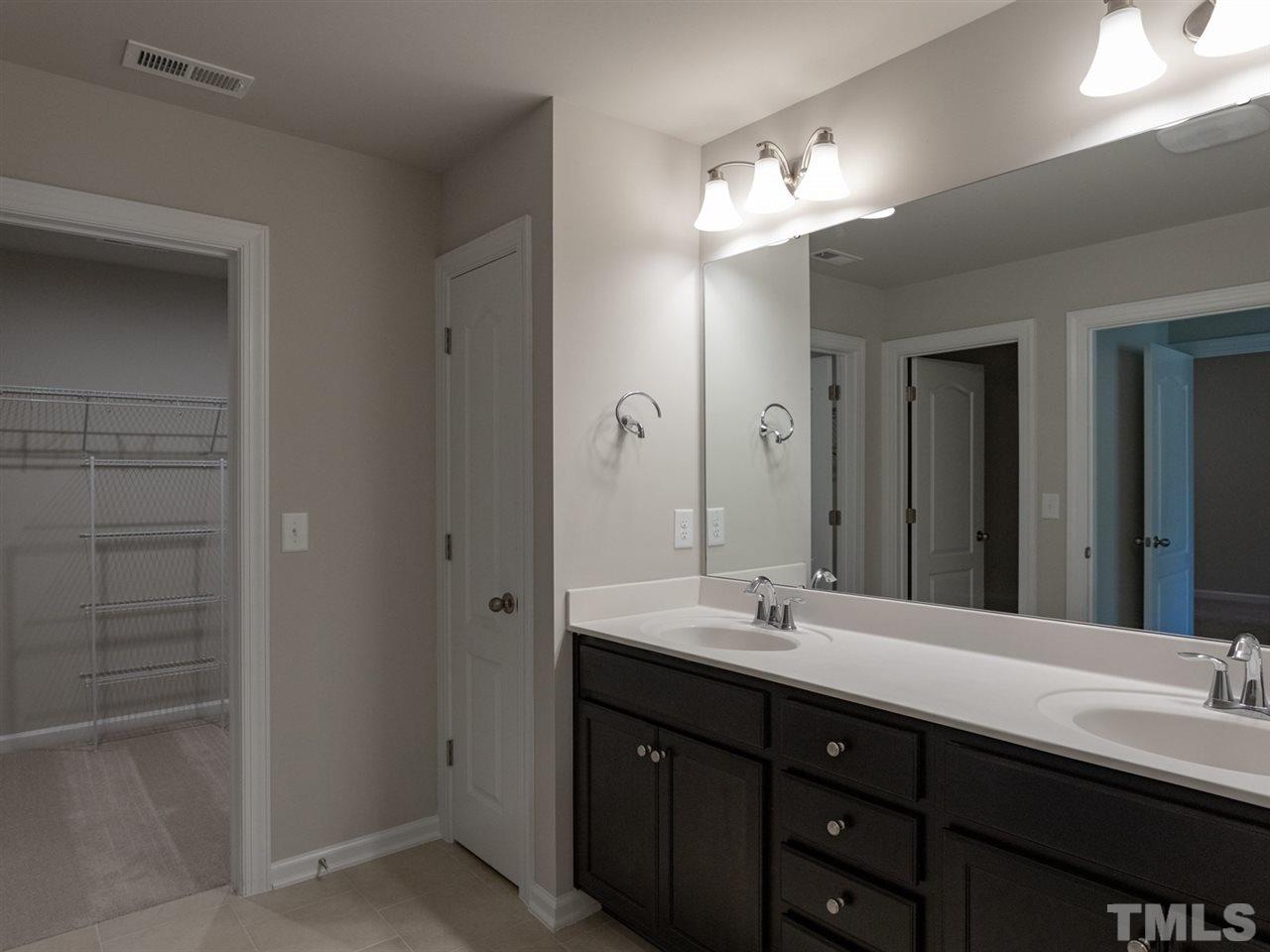 845 Rymark Court Cary, NC 27513 - Photo 17 of 21 a bathroom with a double vanity sink and a mirror