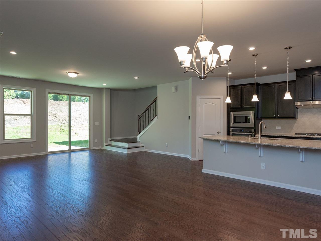 845 Rymark Court Cary, NC 27513 - Photo 3 of 21 a view of a kitchen with a stove and wooden floor
