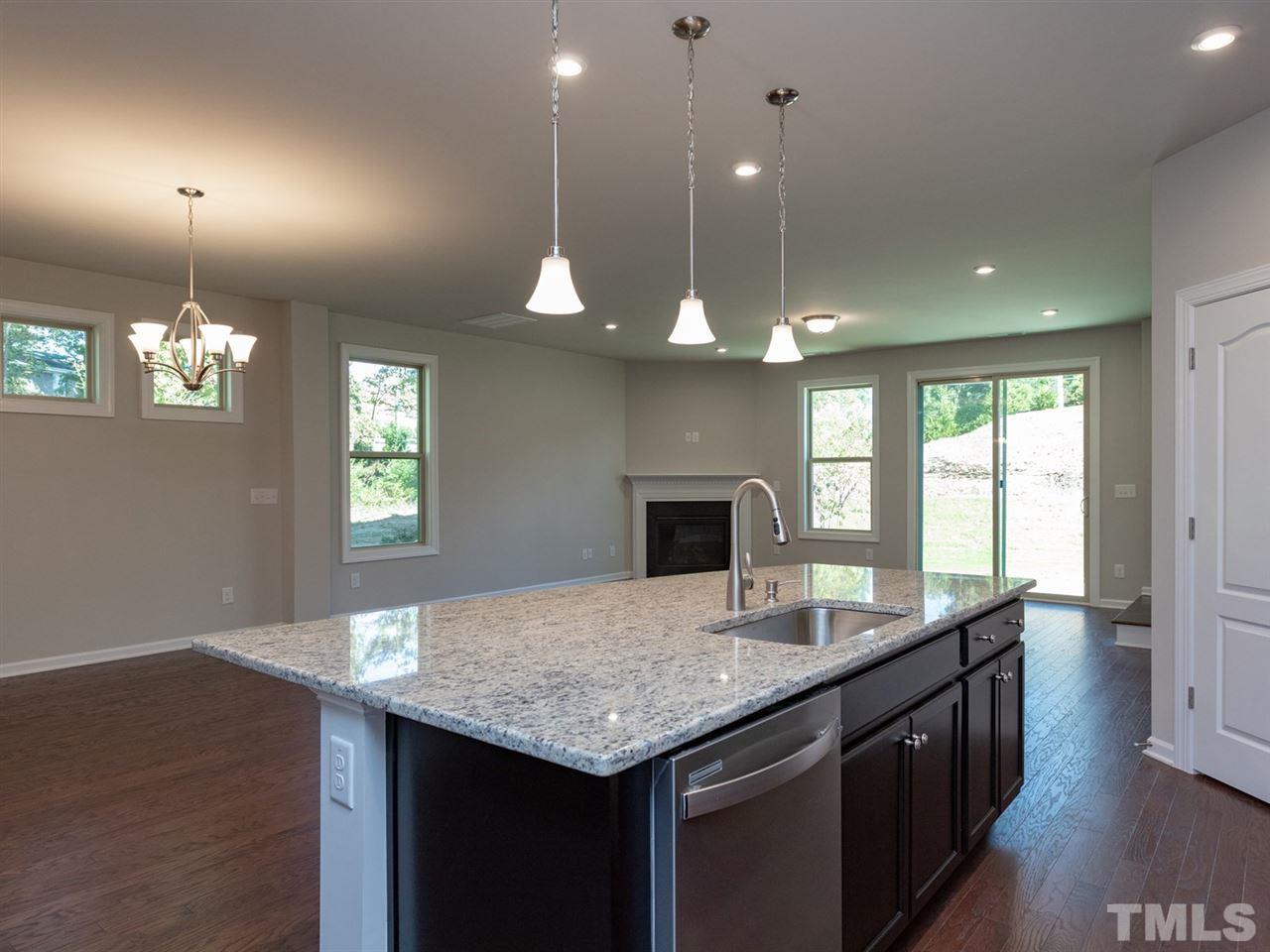 845 Rymark Court Cary, NC 27513 - Photo 5 of 21 a kitchen with a sink chandelier and wooden floor