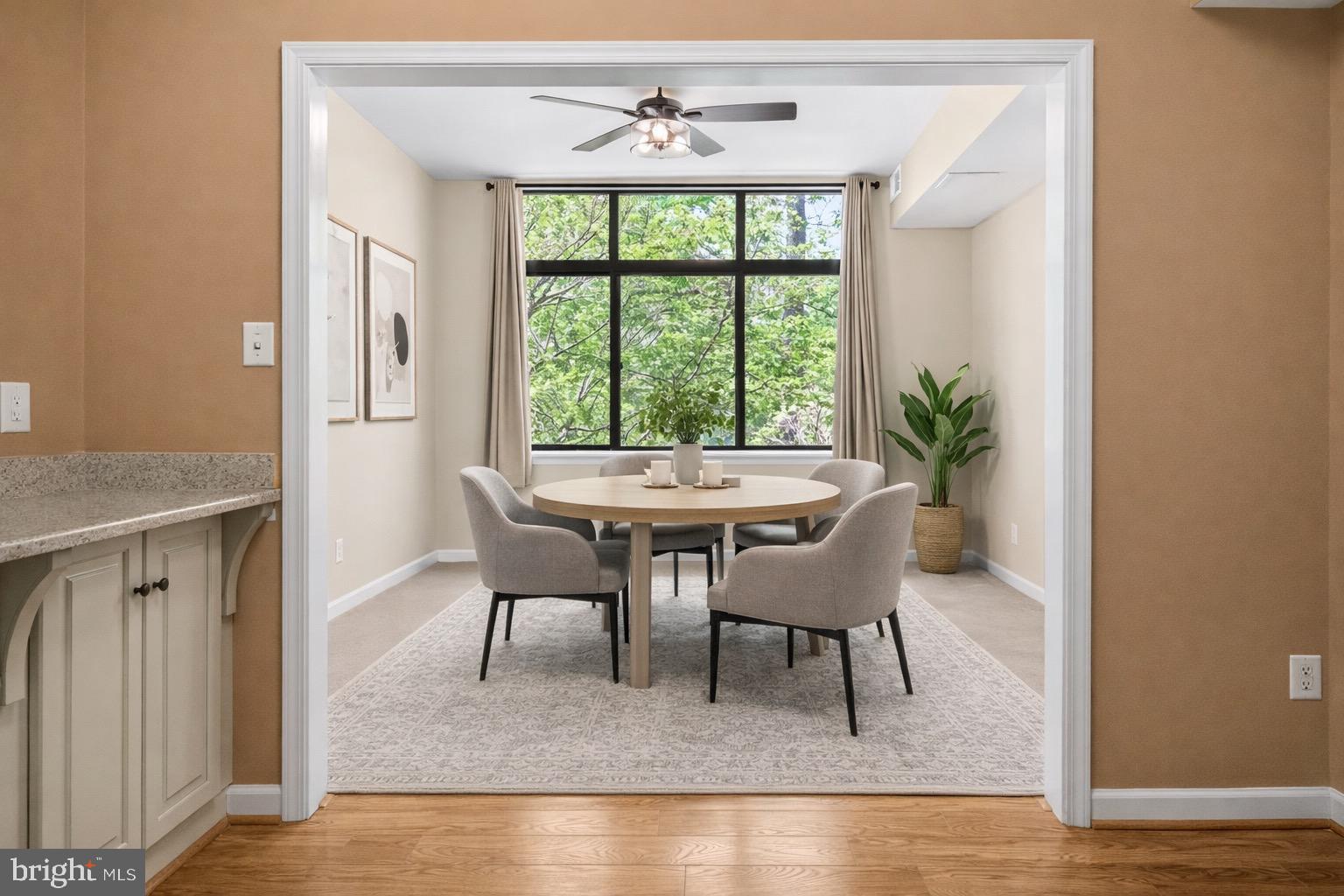 2116 Green Watch Way, Unit 200D Reston, VA 20191 - Photo 16 of 38 a dining room with furniture a window and a chandelier