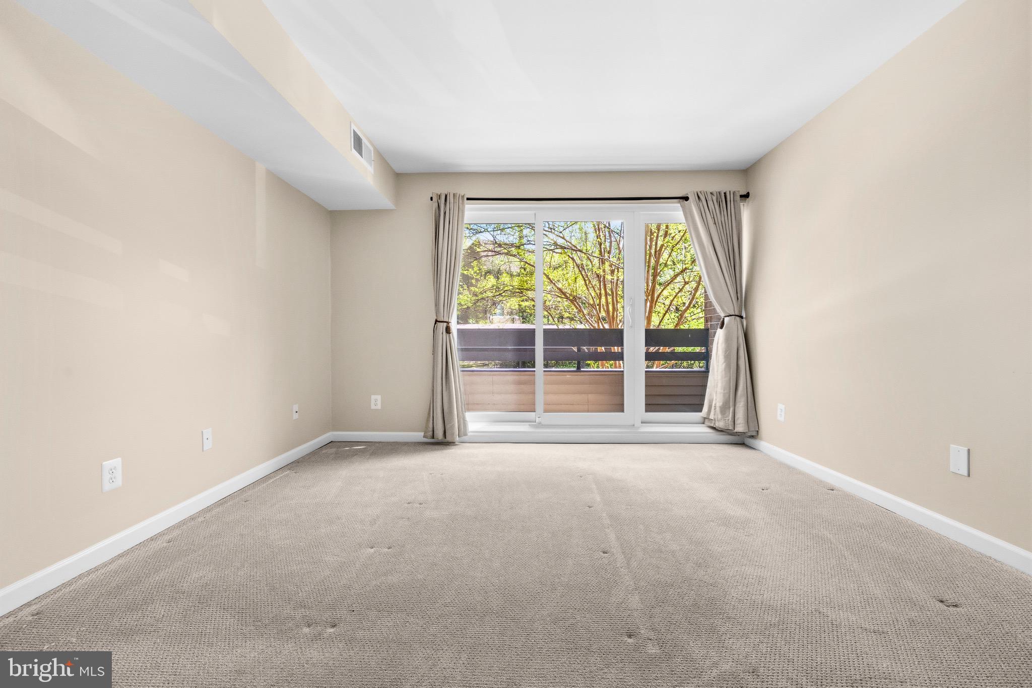2116 Green Watch Way, Unit 200D Reston, VA 20191 - Photo 26 of 38 an empty room with wooden floor and windows
