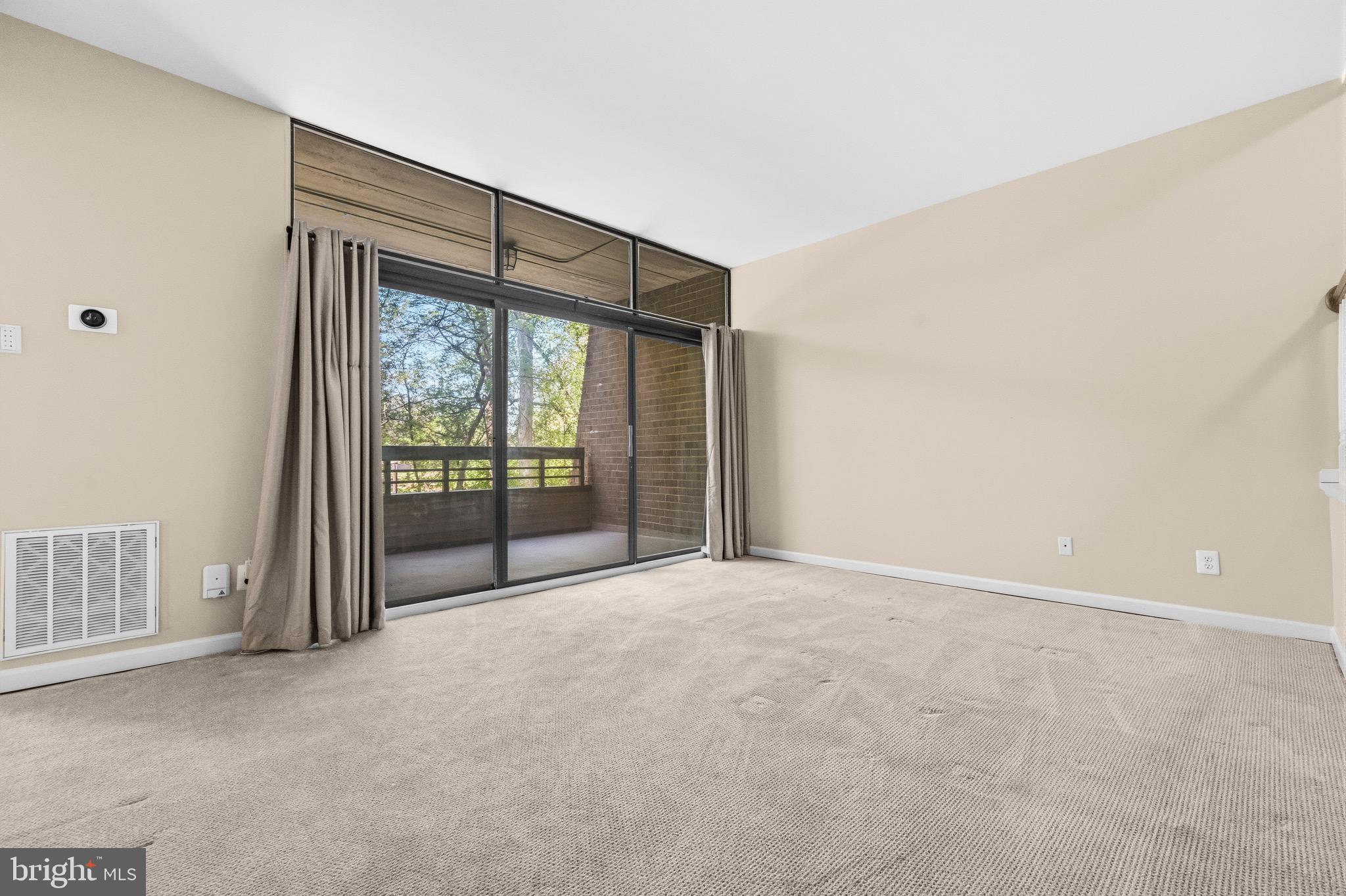 2116 Green Watch Way, Unit 200D Reston, VA 20191 - Photo 6 of 38 a view of an empty room with a balcony