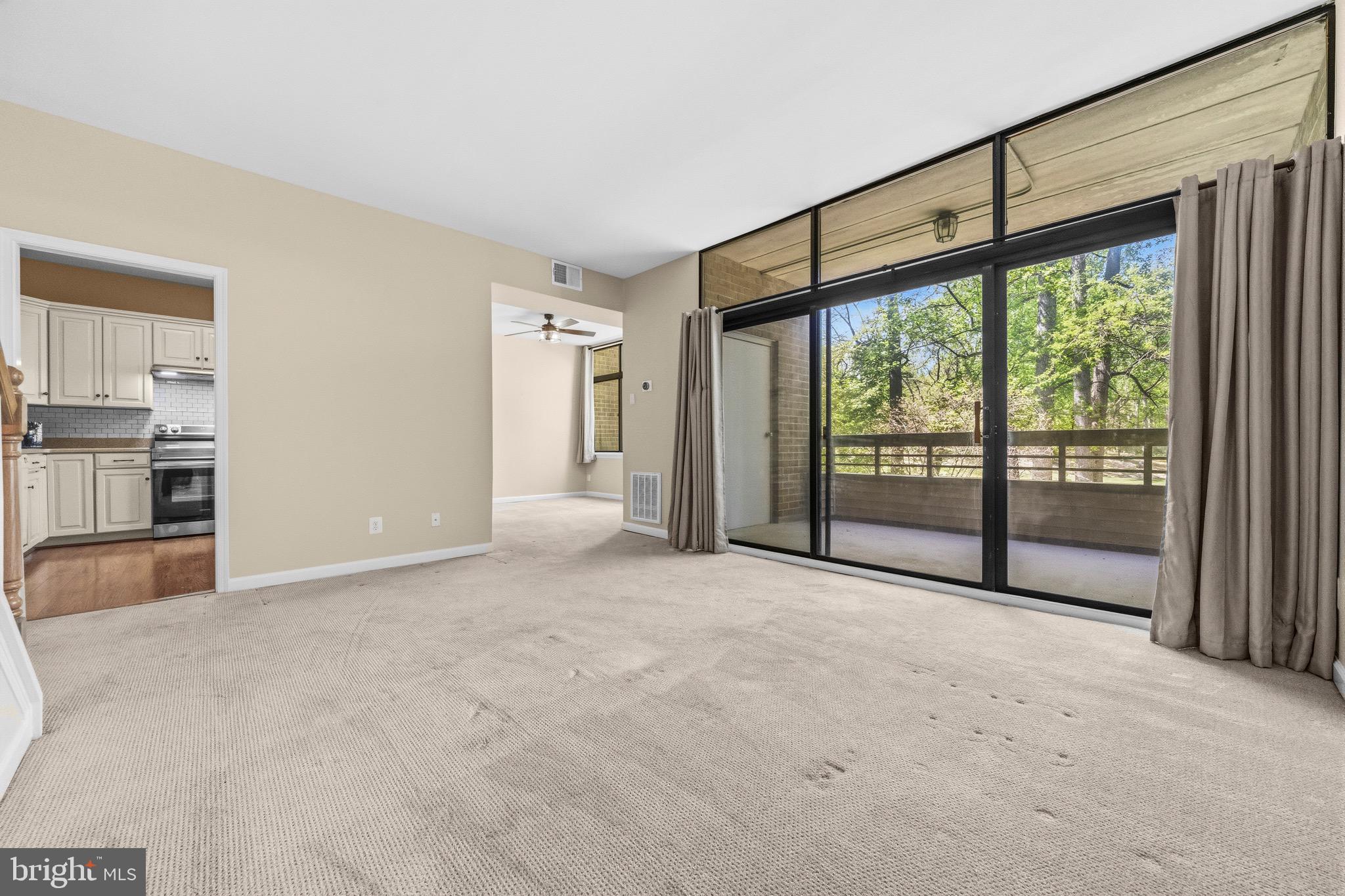 2116 Green Watch Way, Unit 200D Reston, VA 20191 - Photo 7 of 38 a view of an empty room with a fireplace and a window