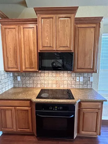 a kitchen with granite countertop cabinets stove and oven