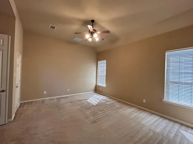 a bathroom with a tub a sink double vanity and a mirror