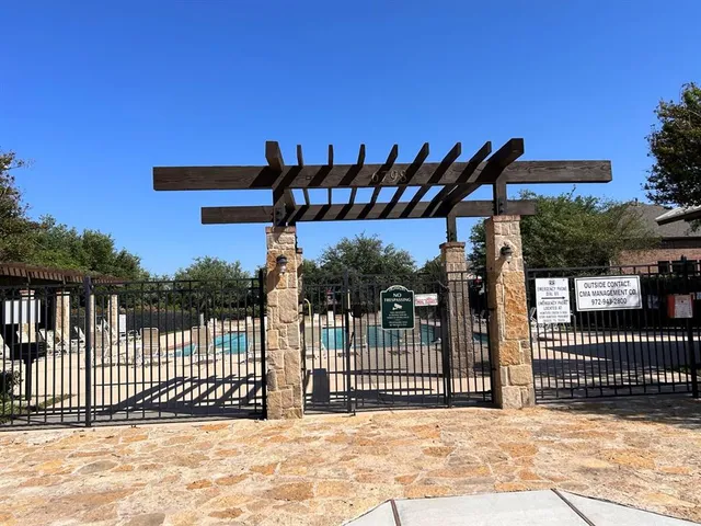 a view of a swimming pool with chairs in patio