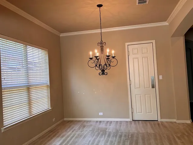 a view of a room with wooden floor and windows