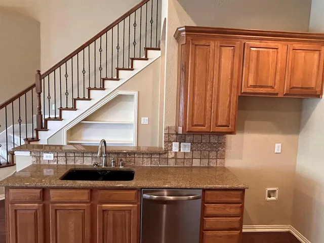 a kitchen with a sink and cabinets