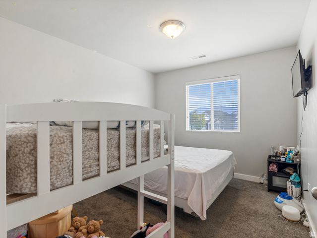 12214 Sunpark Lane Draper, UT 84020 - Photo 17 of 24 Bedroom with dark carpet and baseboards