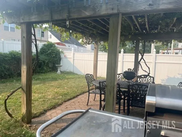 a view of a patio with a table and chairs
