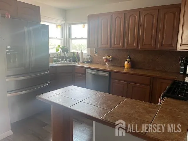 a kitchen with a sink cabinets and appliances