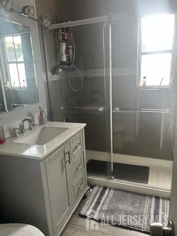 a bathroom with a sink toilet and shower
