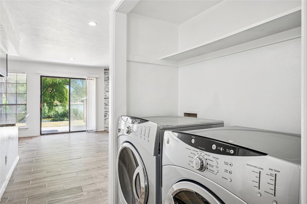 4472 Chaha Road, Unit 103 Garland, TX 75043 - Photo 9 of 16 a view of washer and dryer with kitchen in the background