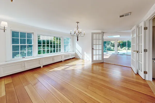 wooden floor in an empty room with a window