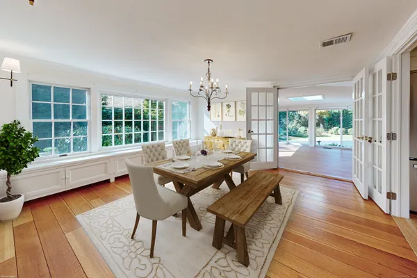 a view of a dining room with furniture window and wooden floor