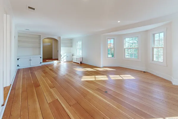a view of a livingroom with wooden floor and window