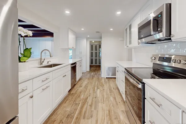 a kitchen with cabinets a sink and appliances