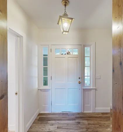a view of a hallway with wooden floor