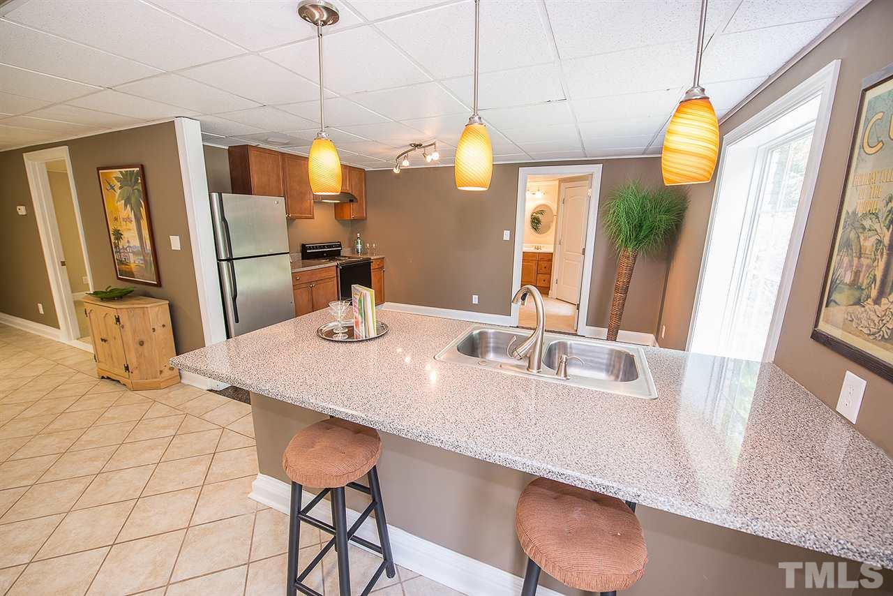 6820 Lake Wheeler Road Raleigh, NC 27603 - Photo 12 of 25 Full kitchen with serving bar in the basement suite.