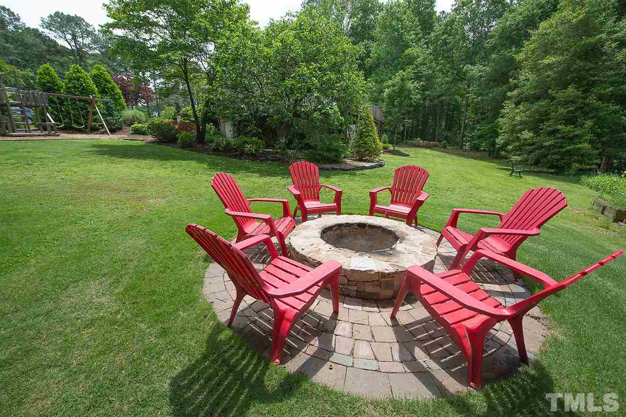 6820 Lake Wheeler Road Raleigh, NC 27603 - Photo 21 of 25 The firepit is another feature of this home’s professional landscaping.