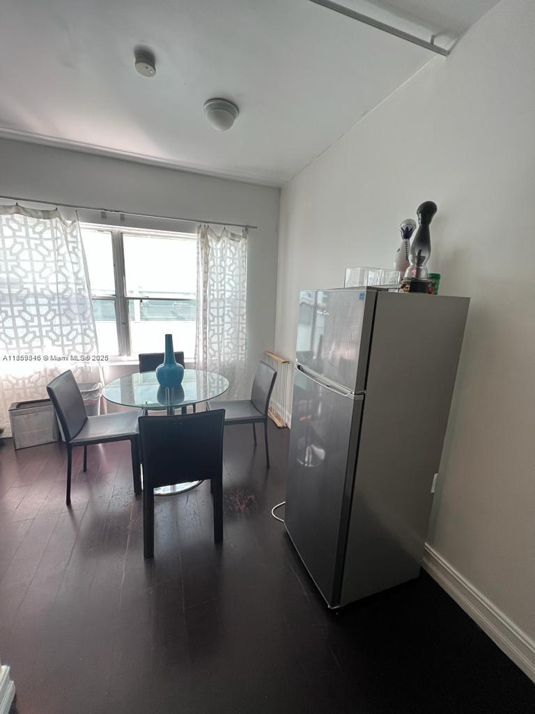 1555 Pennsylvania Avenue, Unit 107 Miami Beach, FL 33139 - Photo 3 of 8 a living room with furniture and a large window