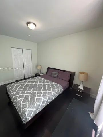 a bed sitting in a room next to a window