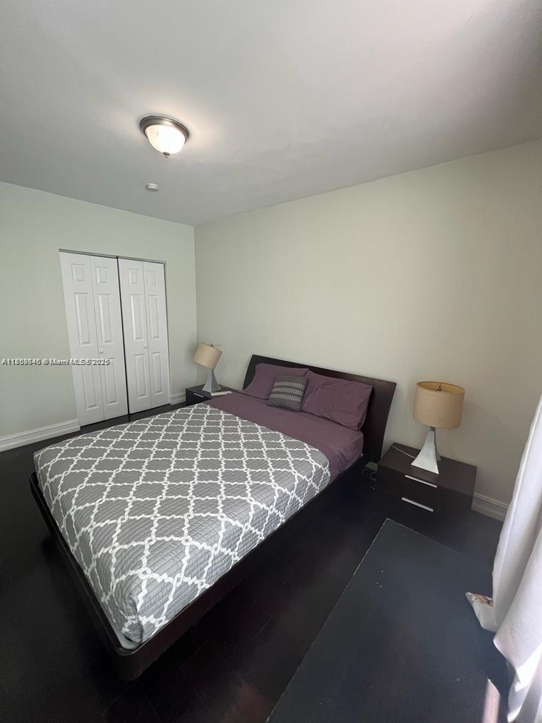 1555 Pennsylvania Avenue, Unit 107 Miami Beach, FL 33139 - Photo 4 of 8 a bed sitting in a room next to a window