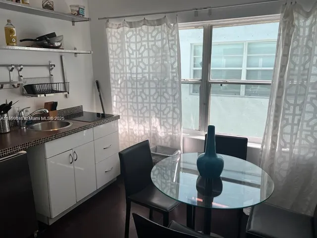 a kitchen with a table and chairs