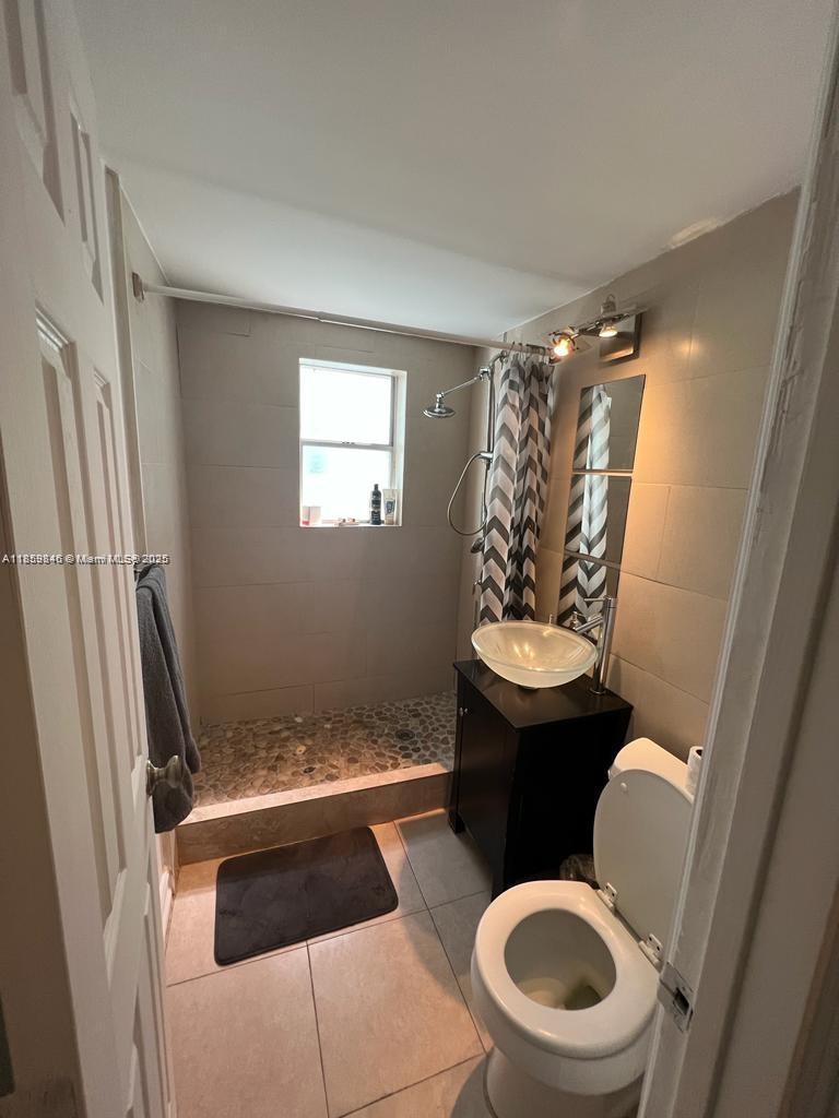 1555 Pennsylvania Avenue, Unit 107 Miami Beach, FL 33139 - Photo 6 of 8 a bathroom with a toilet and a sink