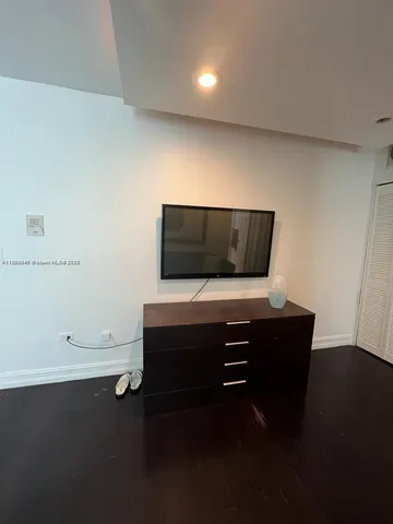 a living room with furniture and a air conditioner vent