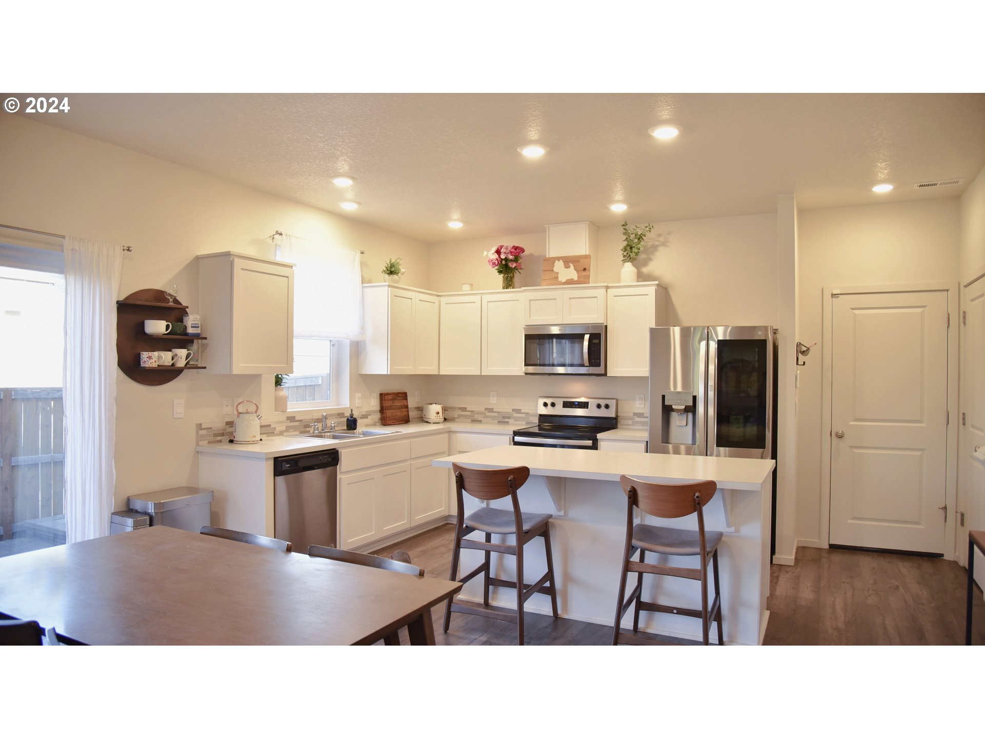 2991 W Street Springfield, OR 97477 - Photo 10 of 43 a kitchen with kitchen island granite countertop a sink cabinets and stainless steel appliances