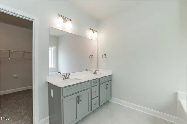 a bathroom with a double vanity sink and mirror