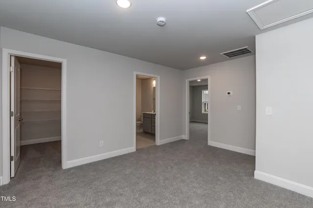 a view of an empty room and closet area