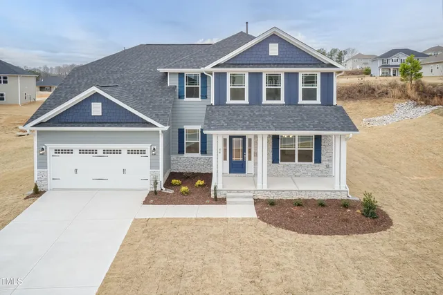 a view of a house with wooden deck and furniture