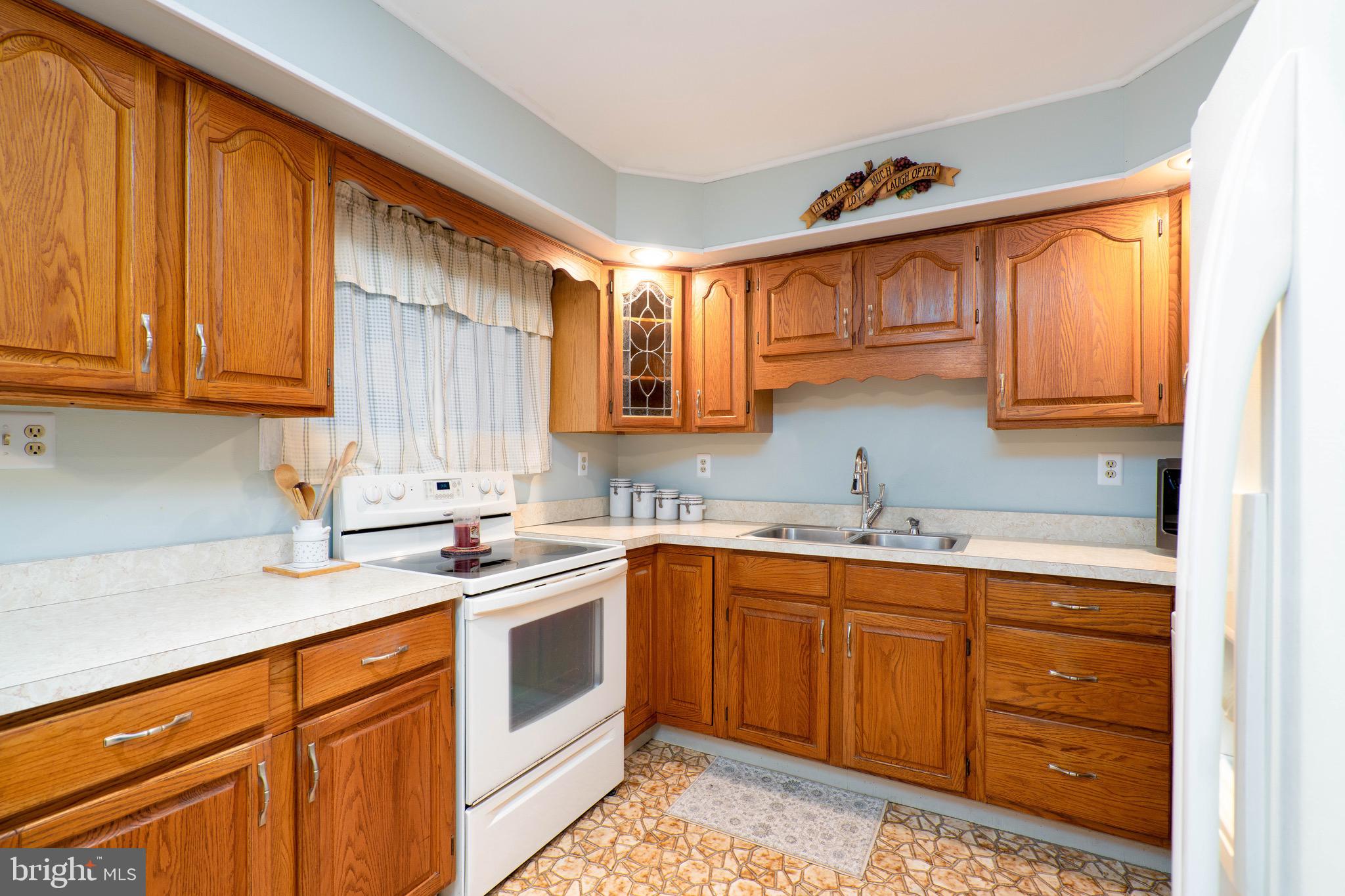 14 Tinder Road Levittown, PA 19056 - Photo 11 of 30 a kitchen with stainless steel appliances granite countertop a sink stove and cabinets